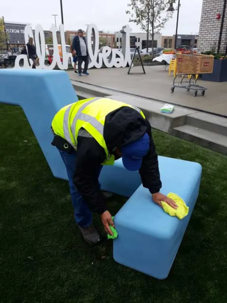 Day porter servicing a common area waste receptacle