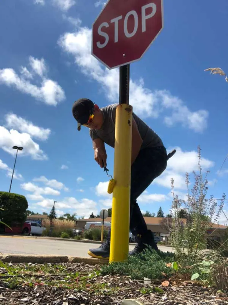 Freshly painted parking lot sign post at a commercial property